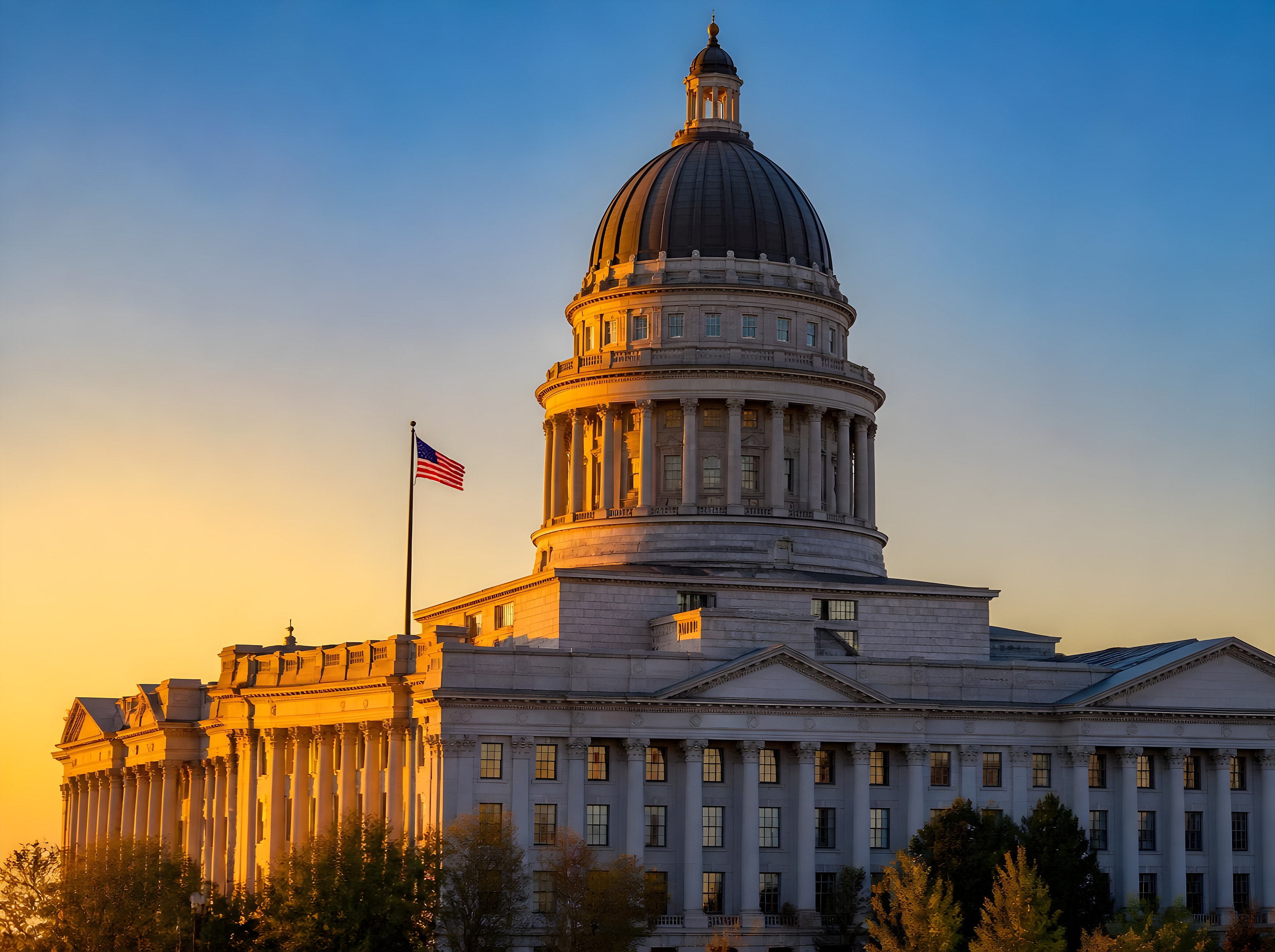 State capitol building with a large dome at sunset