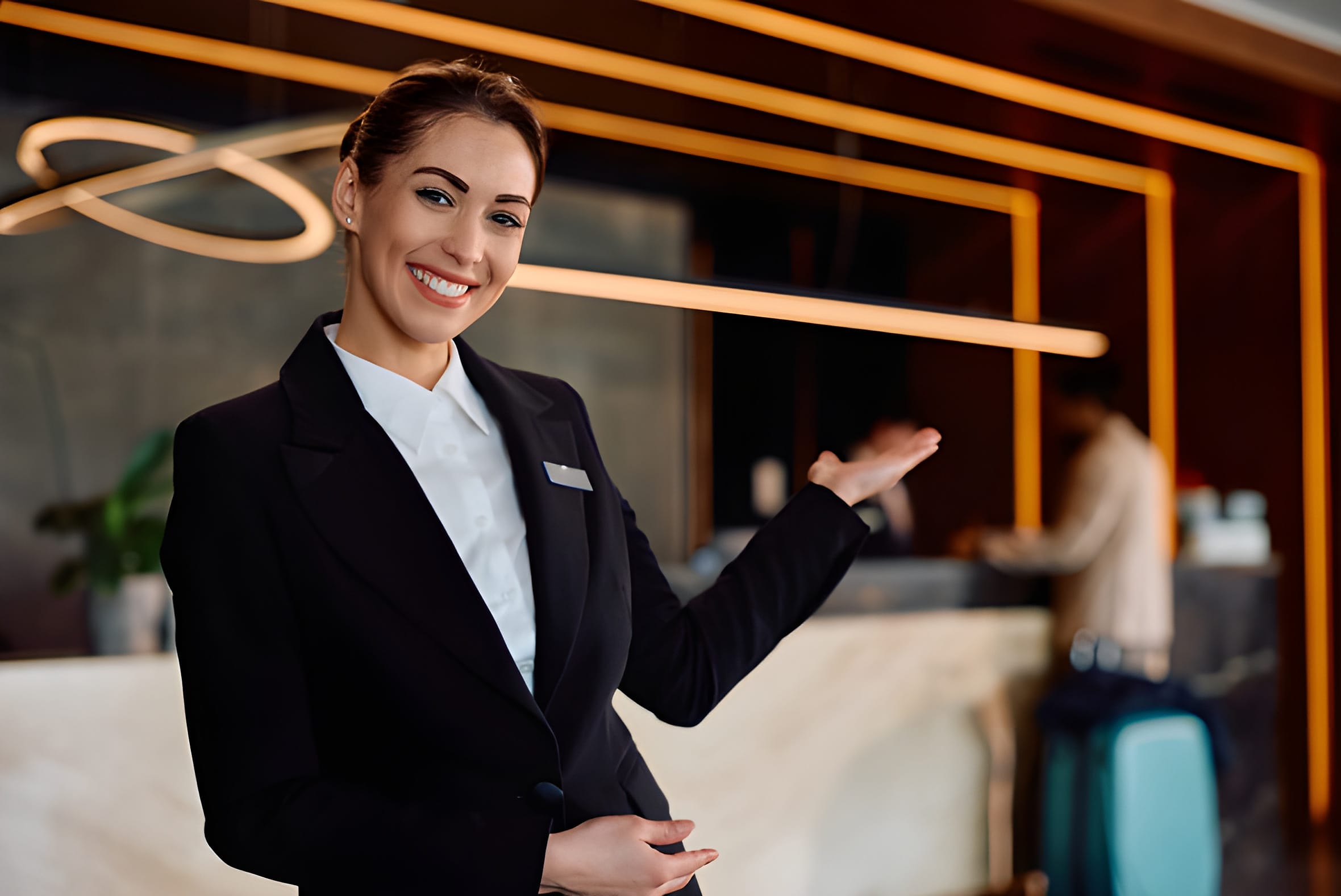 Smiling hotel concierge welcoming guests in a lobby